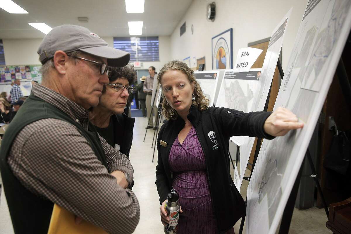 Lisa Eshman, center, Jeff Thayer, left, speak to Christine Fitzgerald as dogs owners came to voice their opinions of the proposed plan to change off-leash access to the Golden Gate National Recreation Area during a meeting with the National Park Service in Montara, Calif., on Tuesday, March 22, 2016. The National Park Service has proposed plans to restrict off-leash access for dogs in some parts of the GGNRA, eliminating them in San Mateo County.