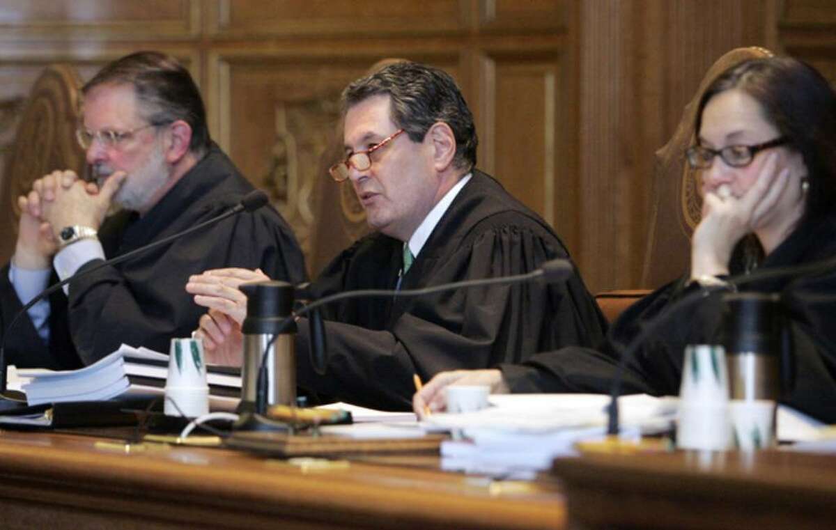 Connecticut state Supreme Court Justice Richard Palmer, center, questions attorneys at the Connecticut Supreme Court in Hartford, Conn., Thursday, March 26, 2009 as the court hears arguments as to why they should throw out Michael Skakel's conviction on murder charges in the 1975 death of 15-year-old Martha Moxley in Greenwich, Conn. From left are: Justice Peter Zarella, Palmer, Justice Joette Katz, who presided.