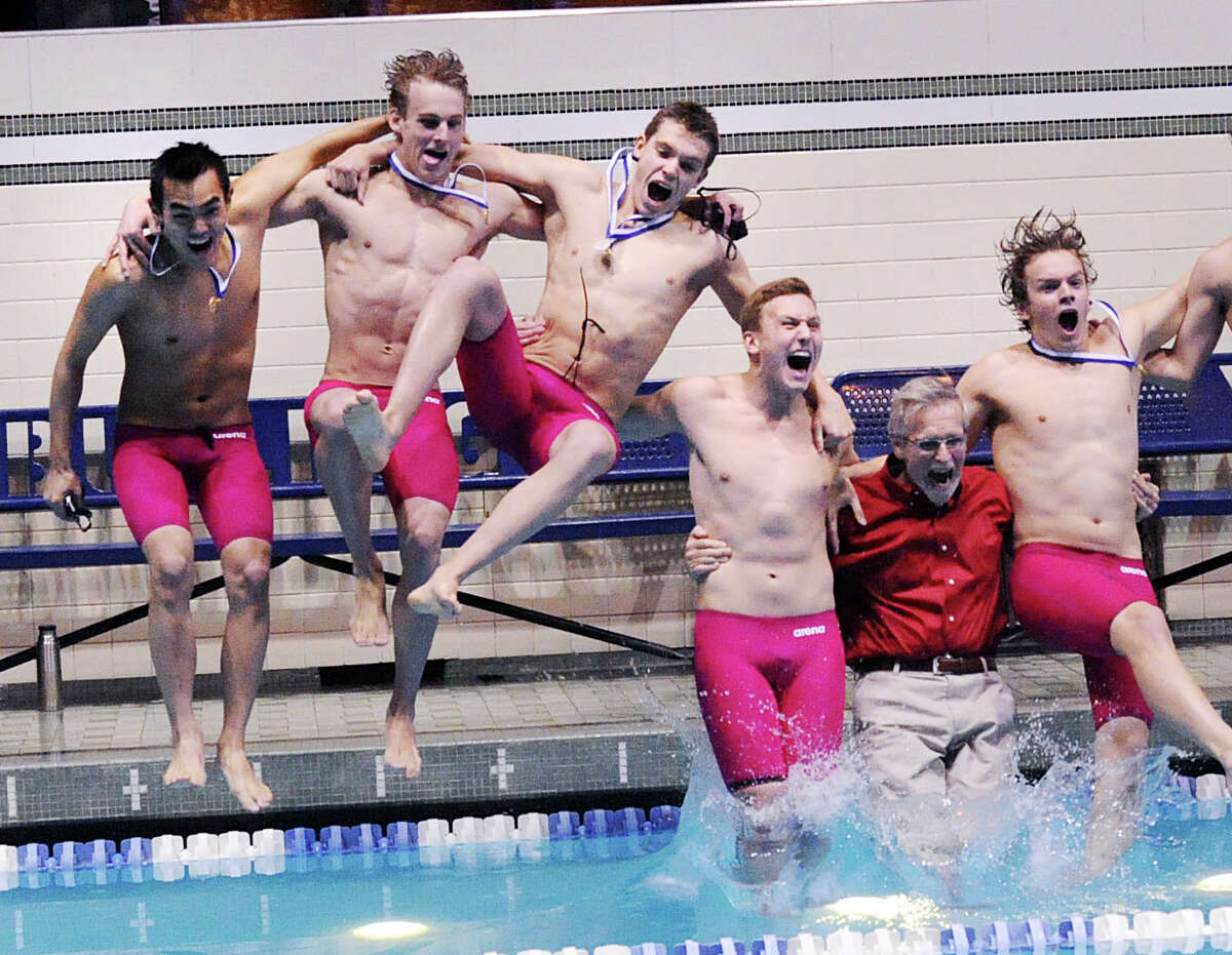 Greenwich swimmers from left, Nicholas Handali, Jack Montesi, Aedan Lewis, Conrad Moss, Greenwich boys swim coach Terry Lowe (red shirt) and Nicholas Heydan jump into the Yale University pool after winning the CIAC State Open swimming championships Saturday at Yale University.