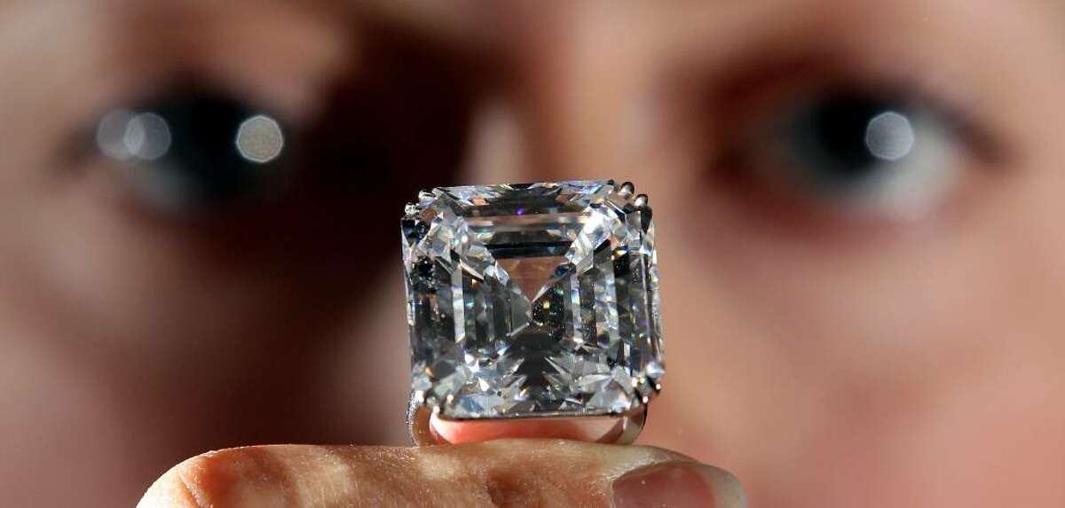 LONDON, ENGLAND - APRIL 12: A Sotheby's employee holds a rare 52.82-carat white diamond ring at Sotheby's auction house on April 12, 2010 in London, England. The ring makes up part of the Geneva Magnificent Jewels Sale which takes place on 11 May, 2010 at Sotheby's in Geneva, and is expected to fetch approximately 7 million USD. (Photo by Dan Kitwood/Getty Images)