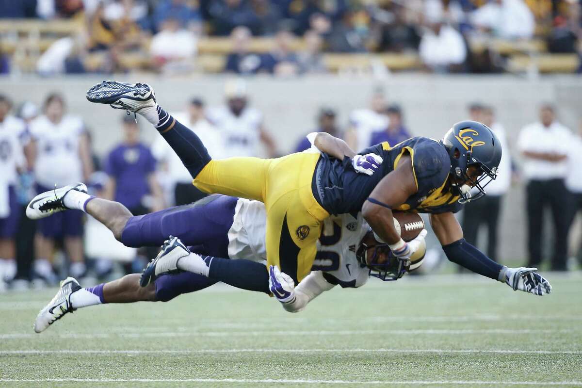 BERKELEY, CA - OCTOBER 11: Wide receiver Stephen Anderson #89 of the California Golden Bears is tackled by defensive back Kevin King #20 of the Washington Huskies during the fourth quarter on October 11, 2014 at California Memorial Stadium in Berkeley, California. The Huskies defeated the Golden Bears 31-7.