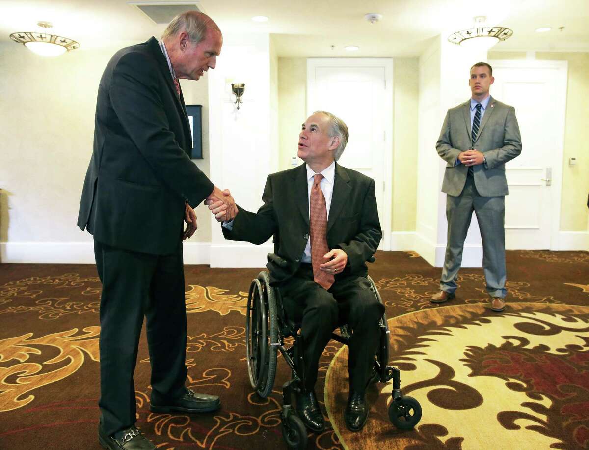 Robert P.Braubach, Consul Honoraire de Belgique (Belgium), steps up to greet Governor Greg Abbott on his way in to the guest speaker at the Rotary Club of San Antonio luncheon at the Embassy Suites on March 23, 2016.