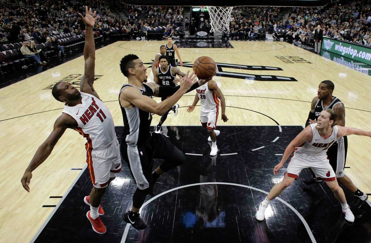 San Antonio Spurs guard Danny Green (14) drives past Miami Heat guard Dion Waiters (11) during the second half of an NBA basketball game Wednesday, Dec. 6, 2017, in San Antonio. San Antonio won 117-105. (AP Photo/Eric Gay)