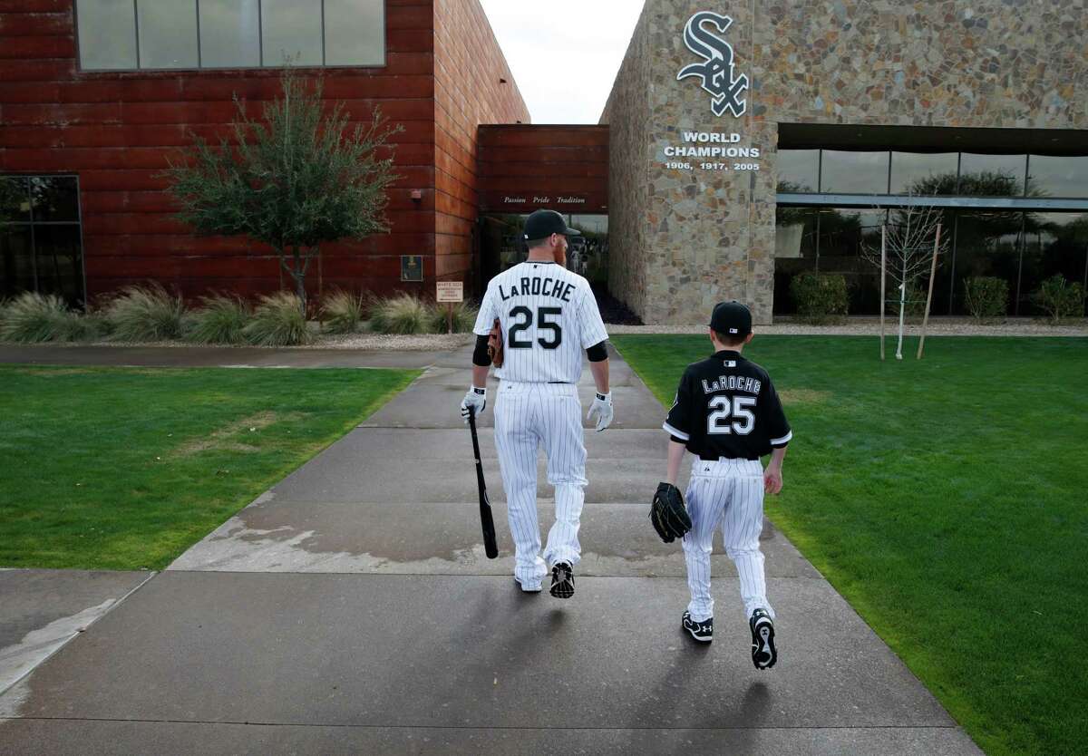 In this Feb. 28, 2015 file photo, Chicago White Sox’s Adam LaRoche, left, and his son Drake walk to the clubhouse during a photo day before a baseball spring training workout in Phoenix, Arizona.
