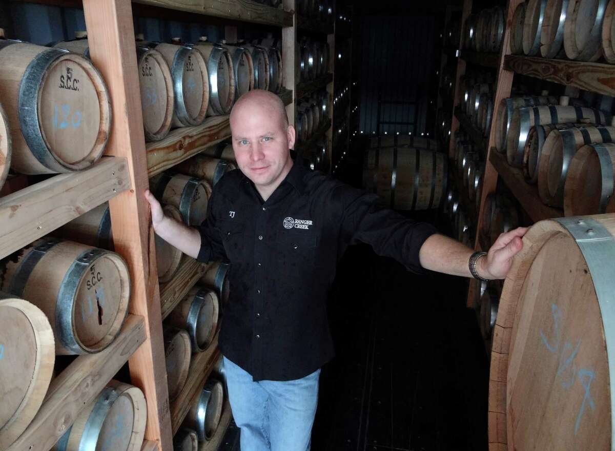 T.J. Miller of Ranger Creek Brewing and Distilling stands amid barrels of aging bourbon in the facility's rackhouse on Saturday, Oct. 8, 2011. BILLY CALZADA / gcalzada@express-news.net
