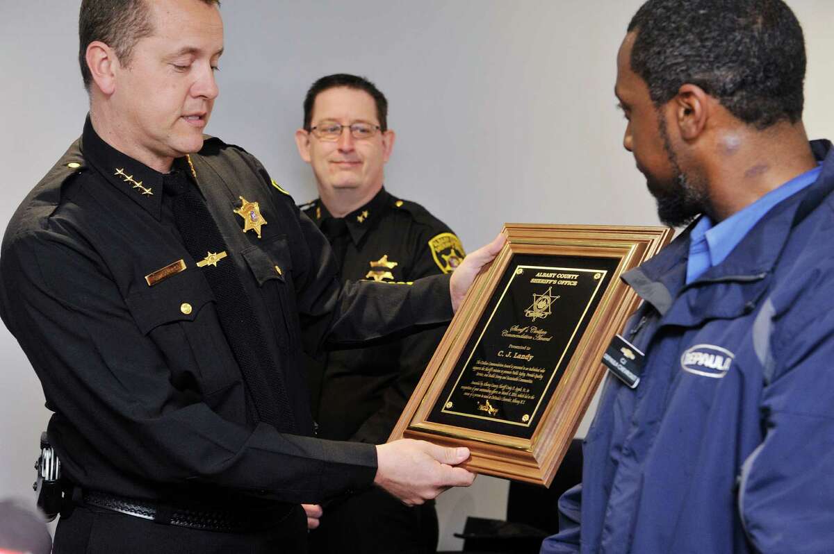 Albany County Sheriff Craig Apple, Sr., left, awards C.J. Landy, an employee of DePaula's Chevrolet, the Civilian Commendation Award during a ceremony on Thursday, March 24, 2016, in Albany, N.Y. Landy received the award for his actions when he discovered an individual, with limited abilities, was left inside a cold unattended vehicle, which was dropped off for service. The vehicle belonged to the Office for Persons with Developmental Disabilities. Landy alerted authorities which resulted in the person being rescued. (Paul Buckowski / Times Union)