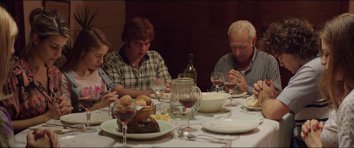 A still from "The Clan."� Guillermo Francella is the white haired man at head of table, Peter Lanzani is the curly haired young man next to him.