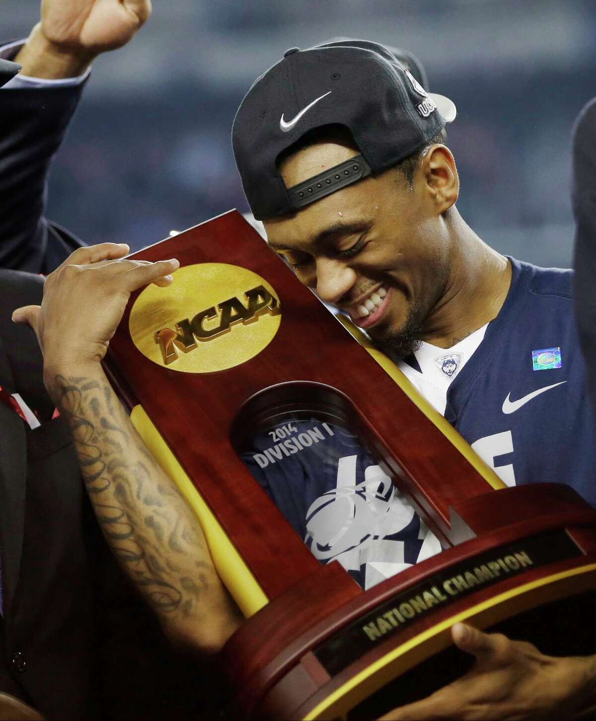 Connecticut guard Ryan Boatright holds the championship trophy after his team won in 2014.