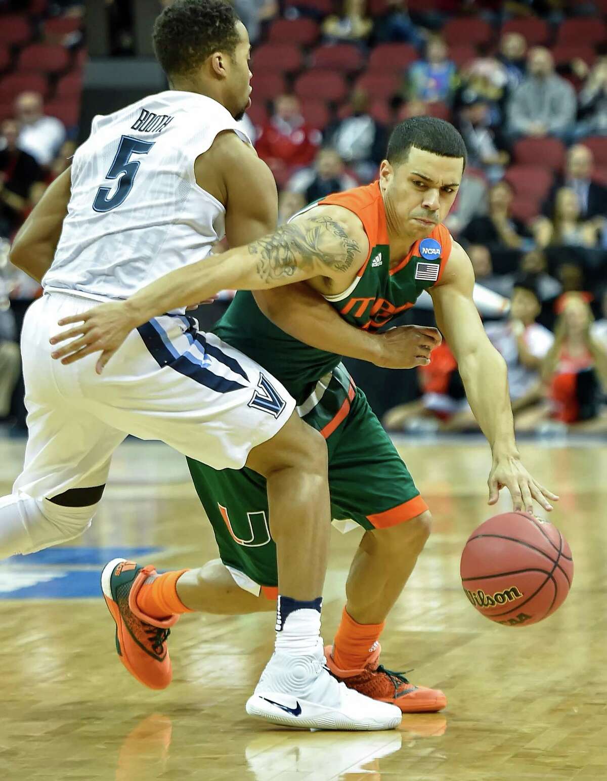 Miami's Angel Rodriguez (13) drives against Villanova's Phil Booth (5) in the first half during a Sweet 16 matchup in the NCAA Tournament's South region at the KFC Yum! Center in Louisville, Ky., on Thursday, March 24, 2016.