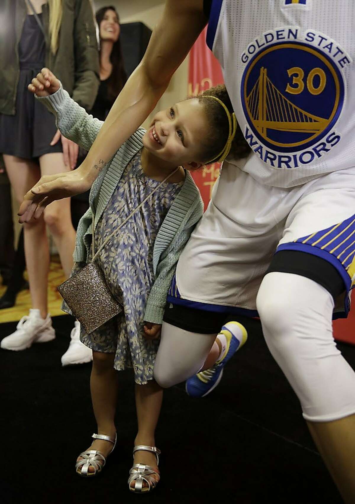 Riley Curry poses under a wax figure of her father, Golden State Warriors guard Stephen Curry, after its unveiling Thursday, March 24, 2016, in Oakland, Calif. The figure of the NBA MVP will go on display at Madame Tussauds wax museum at Fisherman's Wharf in San Francisco. (AP Photo/Eric Risberg)