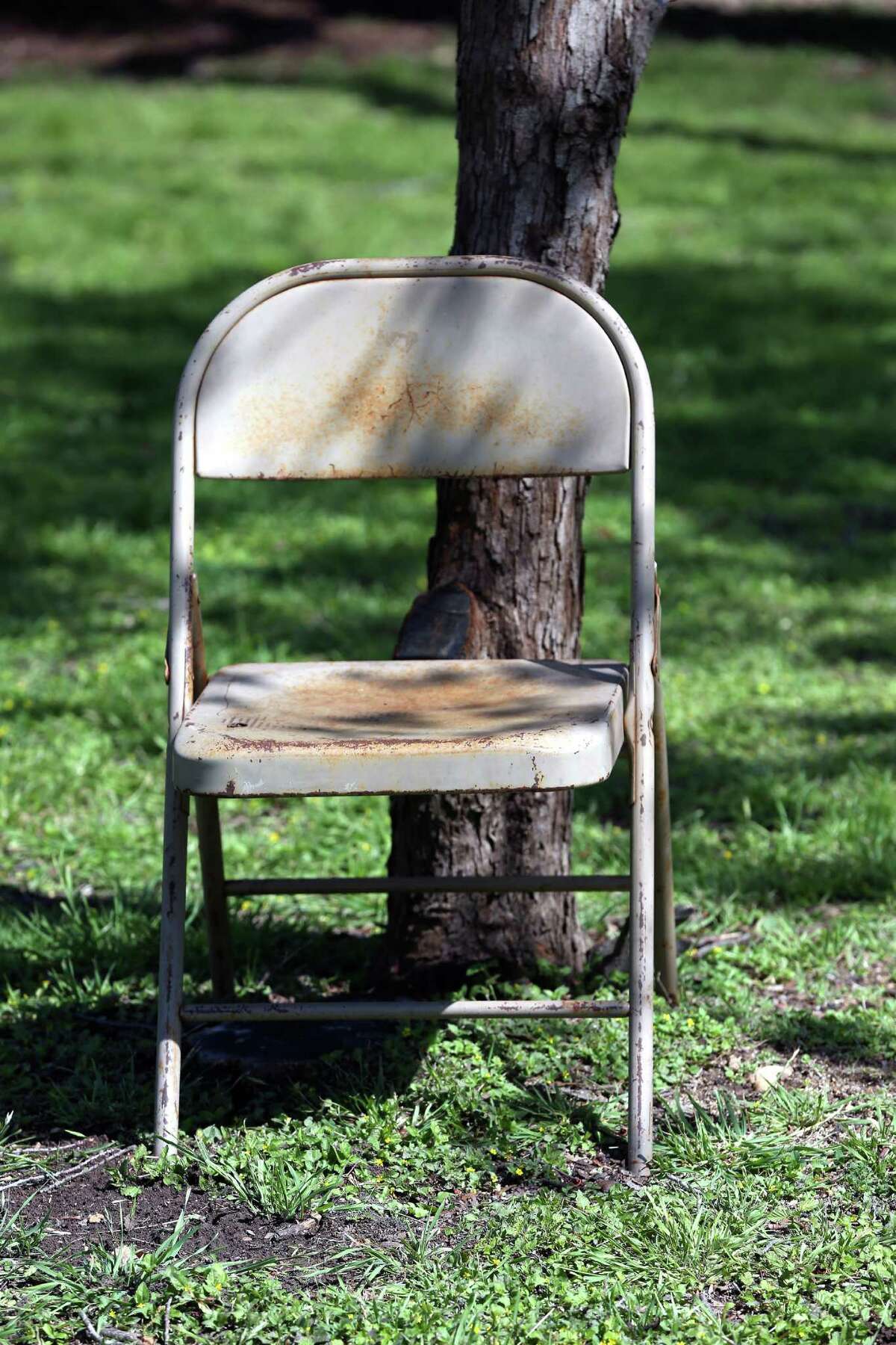 A chair marks a spot Thursday, March 24, 2016 in Brackenridge Park where someone is reserving space for their Easter festivities. Chairs of all kinds begin appearing chained, roped, and simply leaning on just about every possible object in the park as much as a week before Easter as families try to reserve good spots in the park.