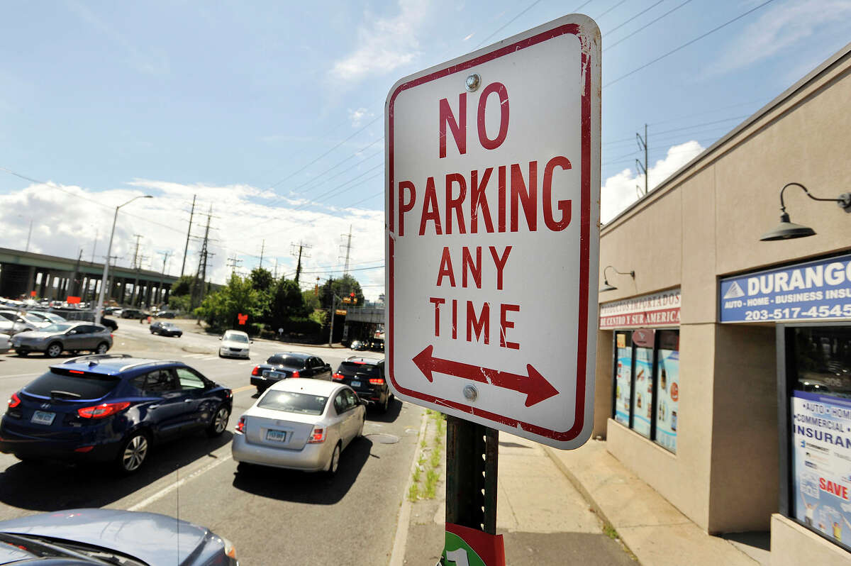 A no parking sign can be seen along East Main Street in front of a row of businesses in Stamford.