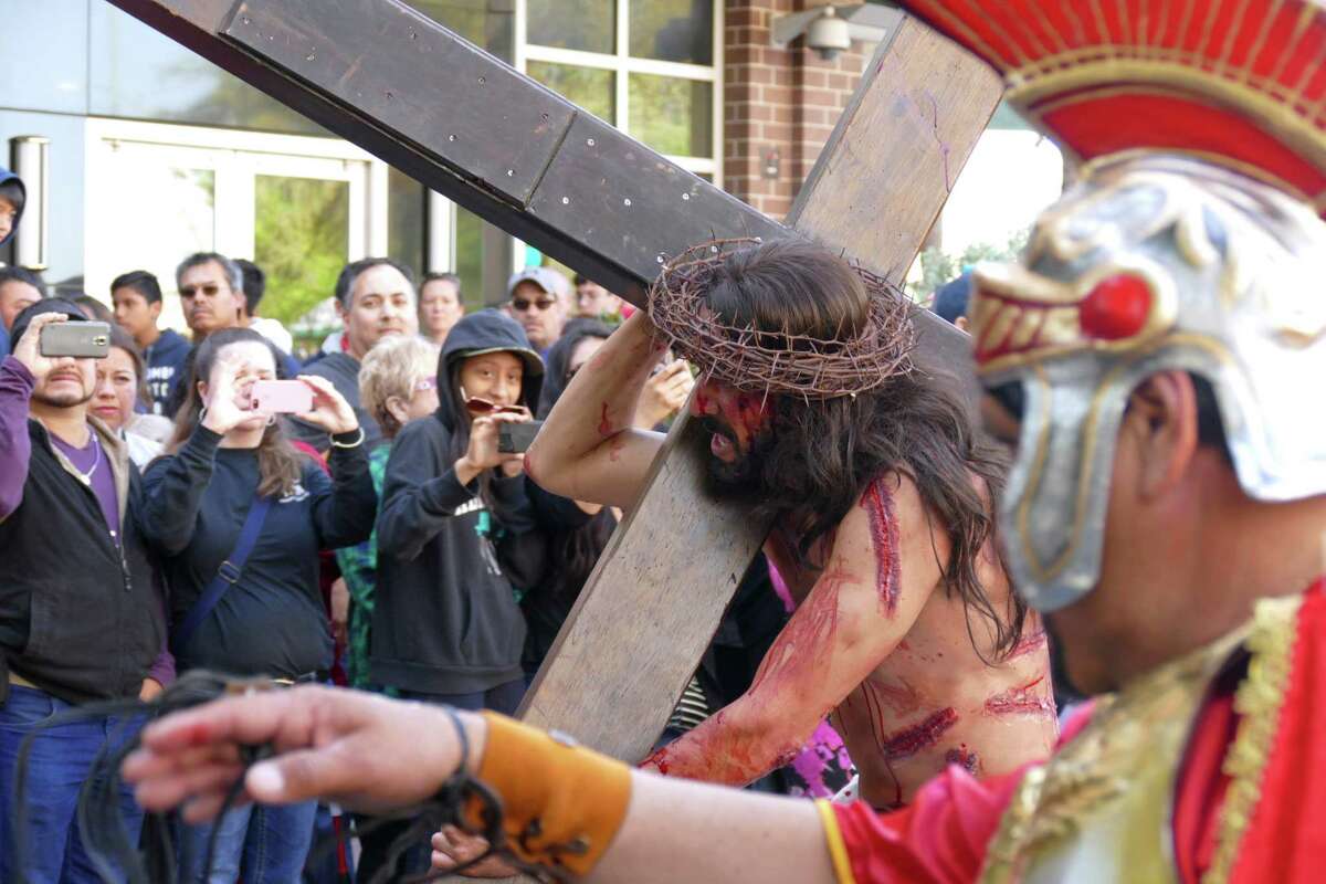 Jesus Christ, played by Luis Amaro, carries the cross along Houston Street in San Antonio during the San Fernando Cathedral Via Crucis, or way of the cross, on Good Friday, March 25, 2016. The event is a reenactment of the events in Jerusalem almost 2,000 years ago, when Jesus Christ was judged and crucified.