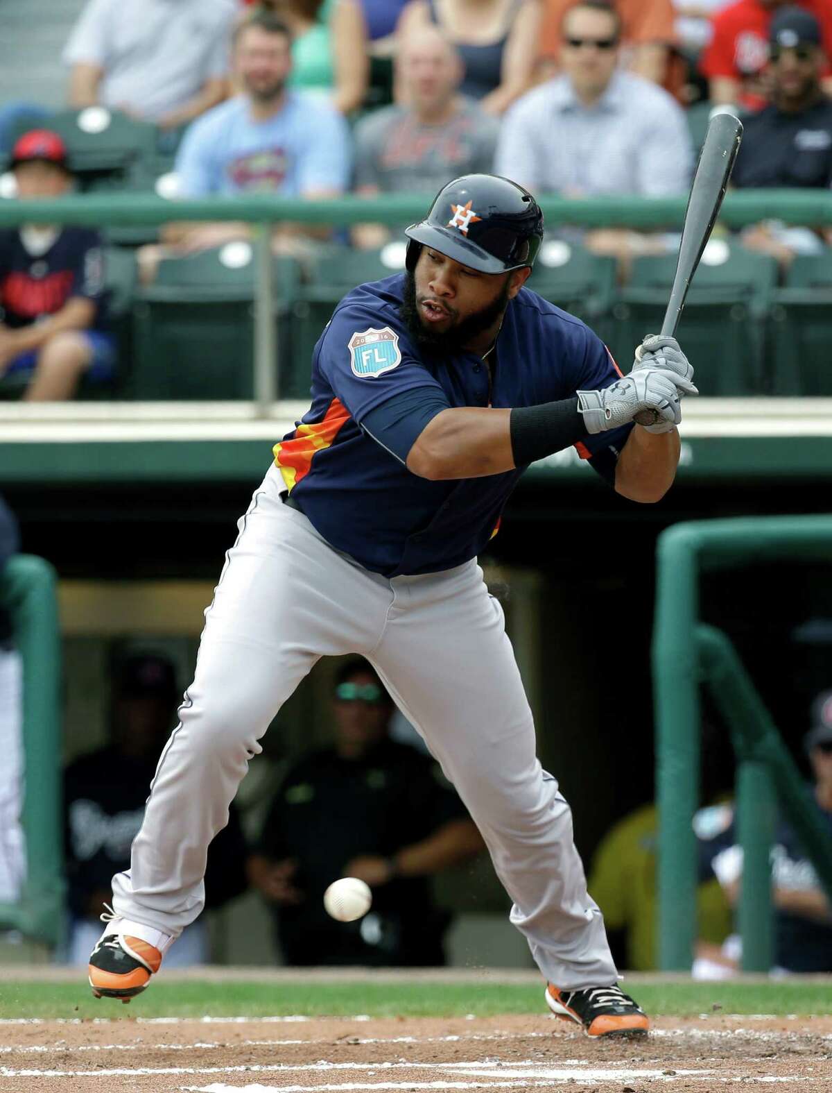 Houston Astros' Jon Singleton jumps back to avoid being hit by an inside pitch in the second inning of a spring training baseball game against the Atlanta Braves, Friday, March 25, 2016, in Kissimmee, Fla.