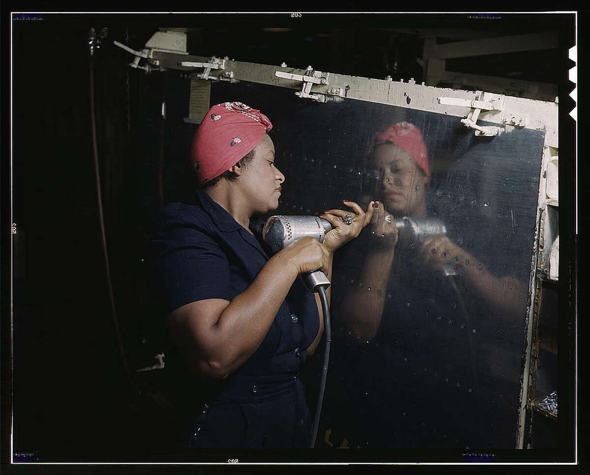 Original caption reads: "Operating a hand drill at Vultee-Nashville, woman is working on a "Vengeance" dive bomber, Tennessee." Photo dated February 1943, by Alfred T. Palmer.