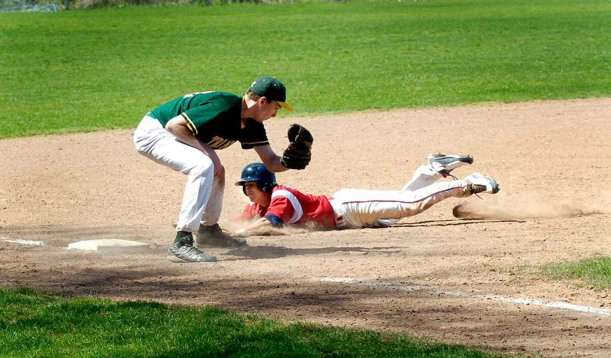 McMahon's Brian Daniello slides into 3rd base as Trinity's RJ Calo tags him out during Brien McMahon vs Trinity Catholic High School baseball at Trinity in Stamford, Conn. on Monday April 12, 2010.