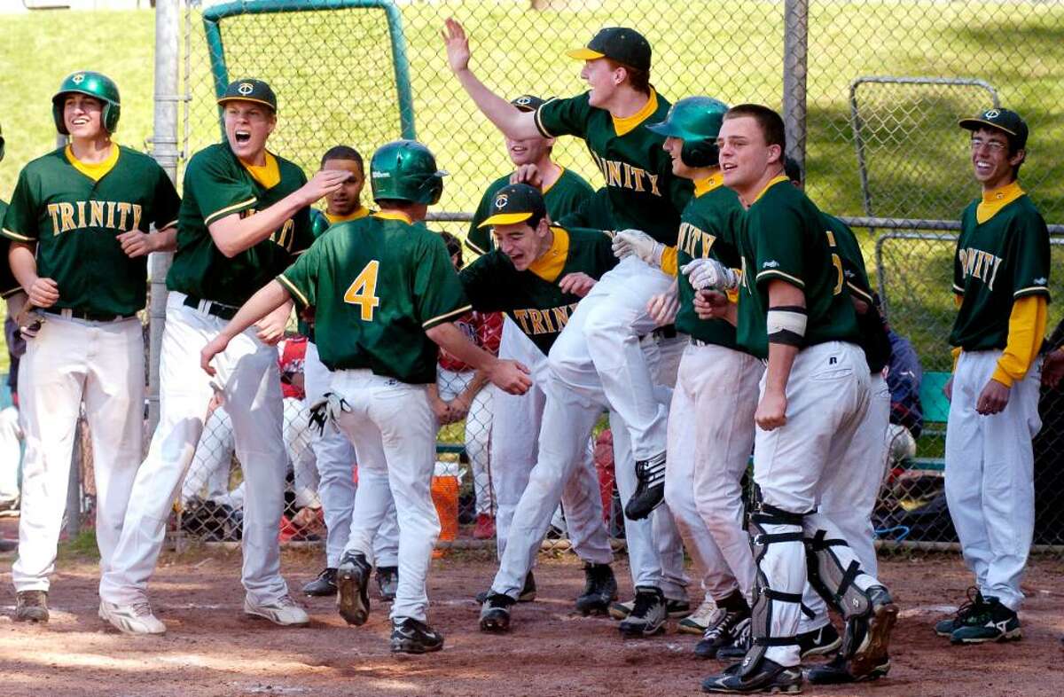 Trinity's players celebrate after Brian O'Neill's grand slam home run in the 9th inning which gave the Crusaders a 7-3 win over Brien McMahon at the Trinity Catholic vs Brien McMahon baseball game at Trinity in Stamford, Conn. on Monday April 12, 2010.