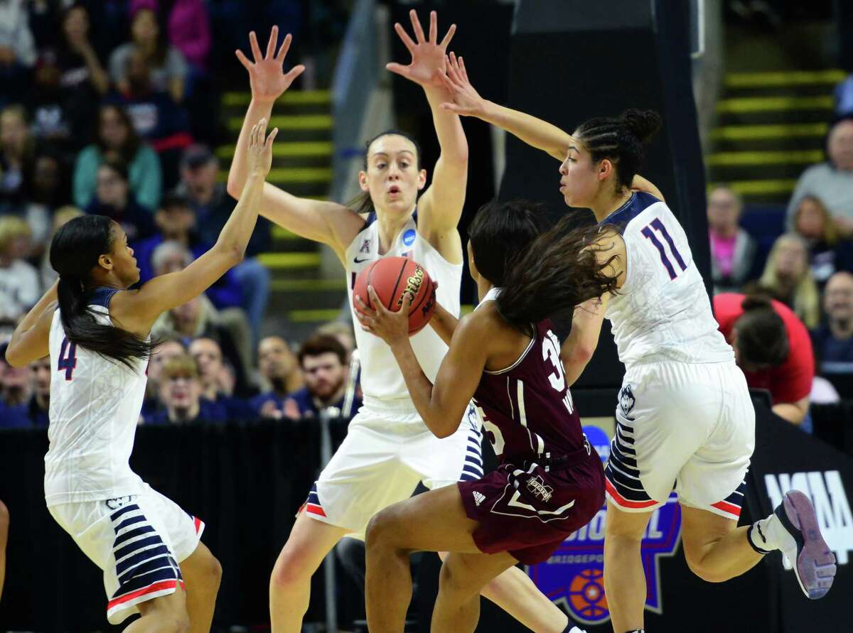 UConn's Moriah Jefferson, left, Breanna Stewart and Kia Nurse, right, surround Mississippi State's Victoria Vivians during NCAA Division I Women's Basketball Championship action at the Arena at Harbor Yard in Bridgeport, Conn., on Saturday March 26, 2016.