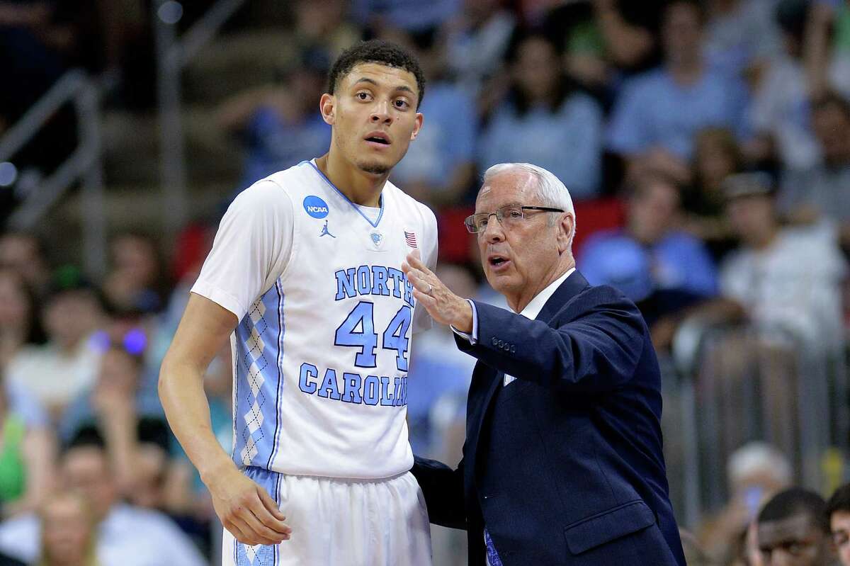 RALEIGH, NC - MARCH 17: Head coach Roy Williams of the North Carolina Tar Heels talks with Justin Jackson #44 in the first half against the Florida Gulf Coast Eagles during the first round of the 2016 NCAA Men's Basketball Tournament at PNC Arena on March 17, 2016 in Raleigh, North Carolina.