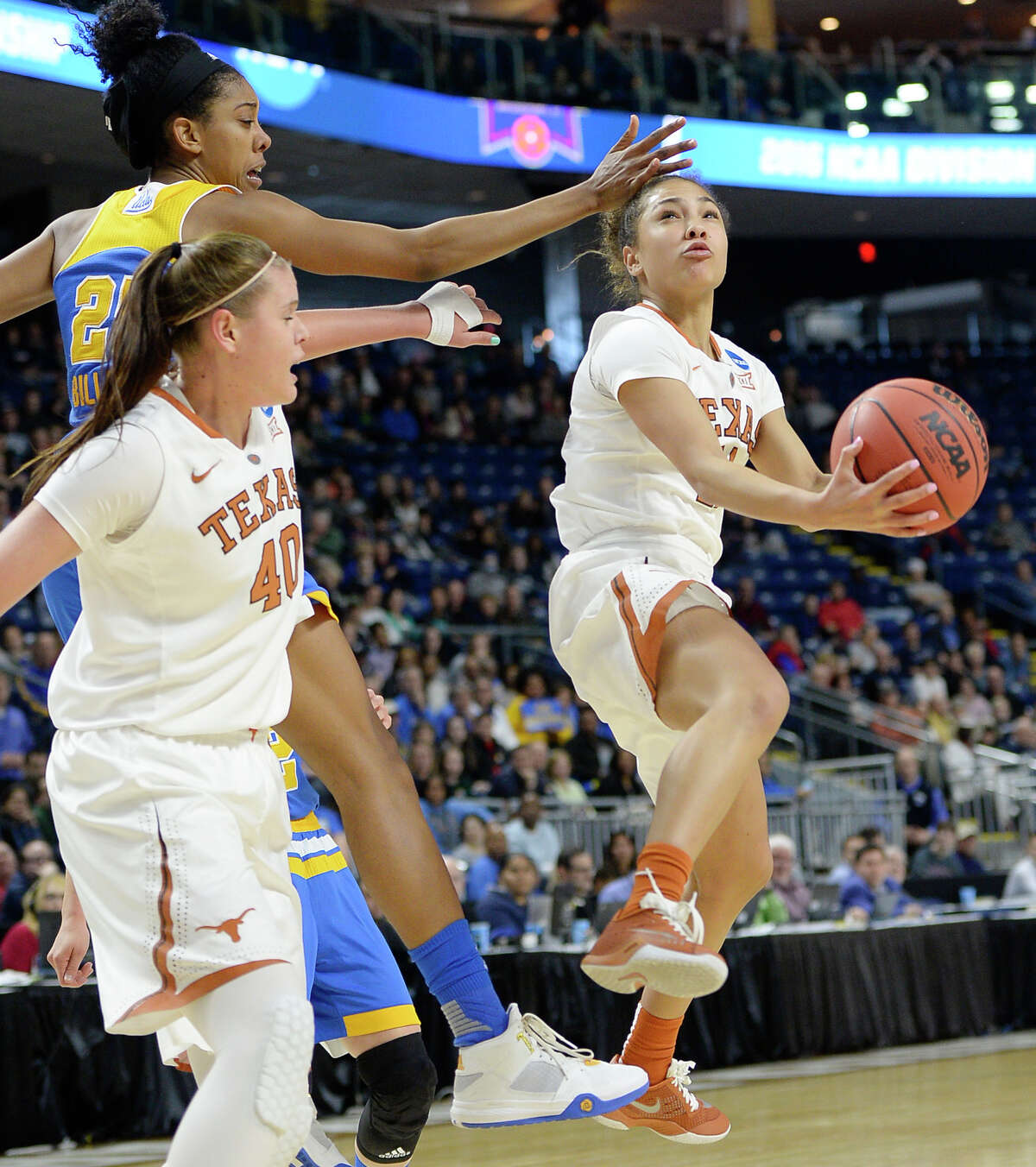 Texas?’ Brooke McCarty, right, shoots against UCLA?’s Monique Billings, back left, as teammate Kelsey Lang defends during the second half of an NCAA college basketball game in the regional semifinals of the women's NCAA Tournament, Saturday, March 26, 2016, in Bridgeport, Conn. Texas won 72-64. (AP Photo/Jessica Hill)
