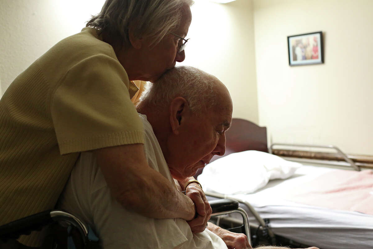 Caroline Cavazos kisses her husband, Army Gen. Richard Cavazos (retired), as she gets him ready for bed at the Army Residence Community in San Antonio on February 2, 2016.