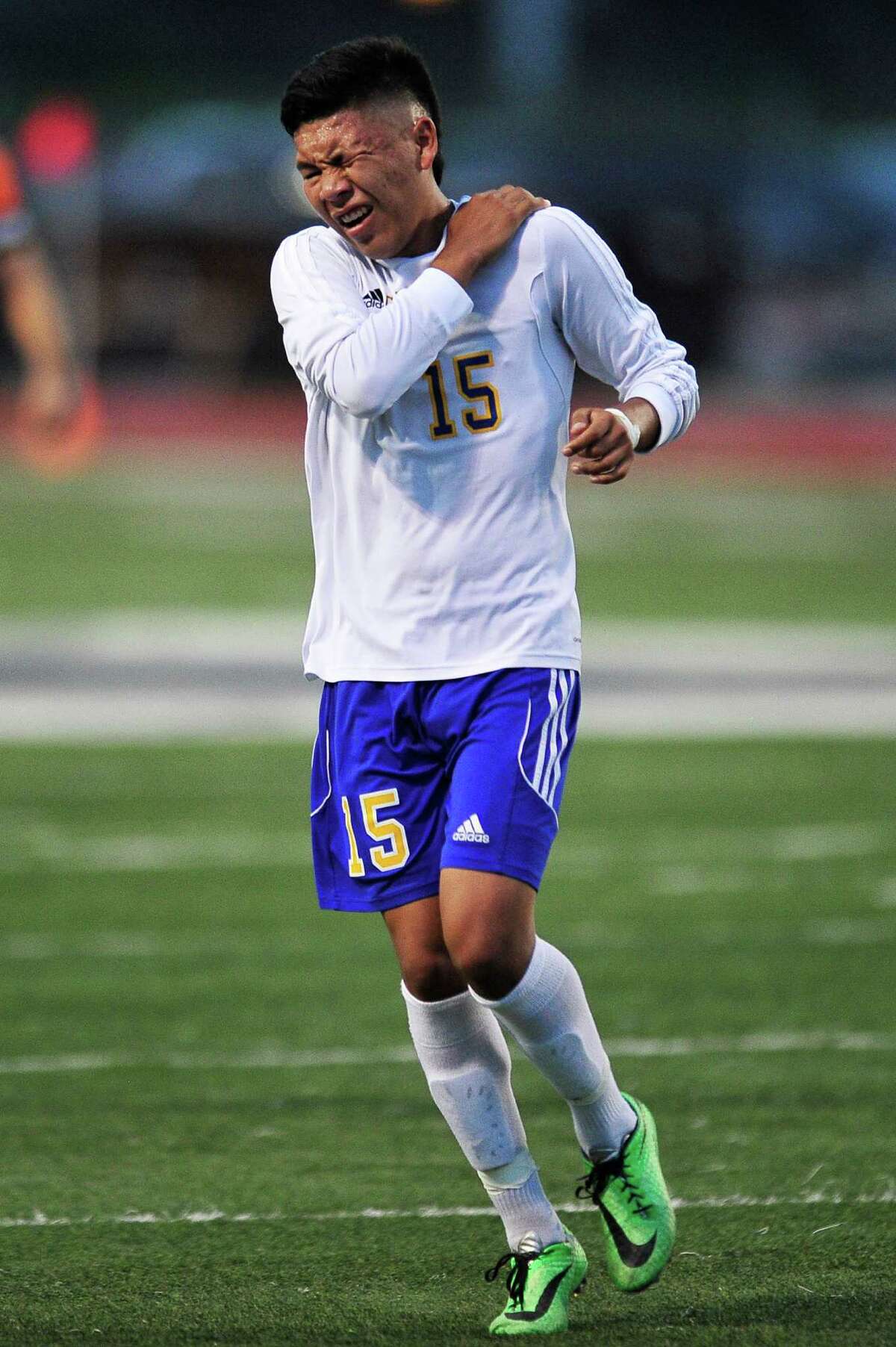 Clemens’s Michael Maldonado reacts after being kicked during the Class 6A third-round boys playoff game between Brandeis and Clemens on April 7, 2015 in San Antonio.