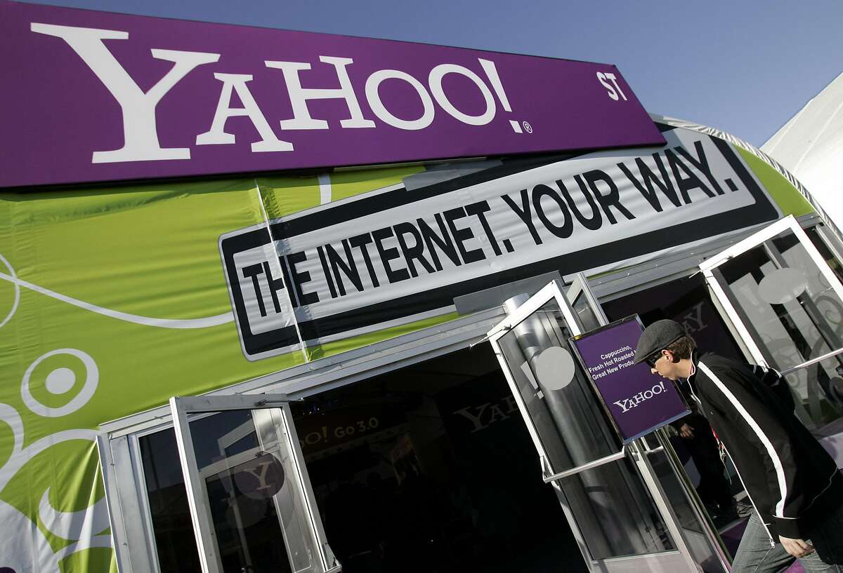 The Yahoo tent at the Consumer Electronics Show (CES) is seen in Las Vegas, Monday, Jan. 7, 2008. Battered by slow revenue growth and the popularity of social networking Web sites, Yahoo! Inc. is poised to lay off hundreds of workers, according to published reports. (AP Photo/Paul Sakuma)