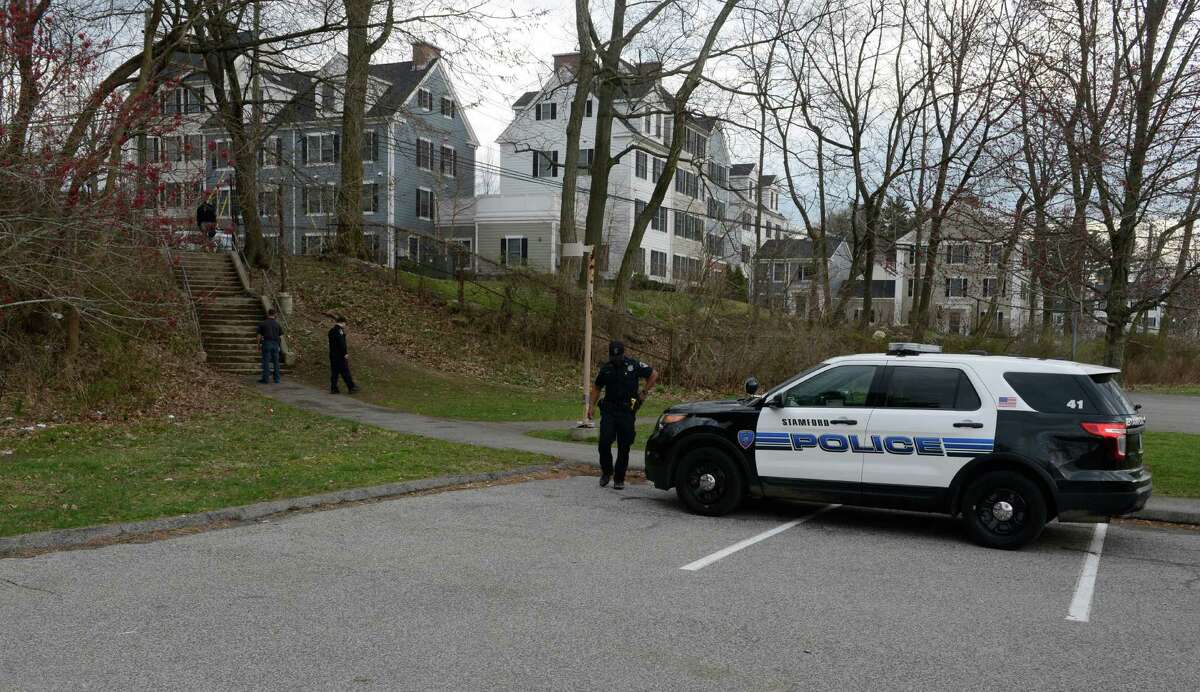 Stamford Police investigate the scene of a shooting near stairs leading from Progress Drive onto the school grounds of Westover Elementary School in Stamford on March 25, 2016.