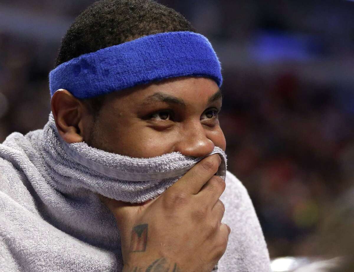 New York Knicks' Carmelo Anthony smiles as he watches his teammates during the second half of an NBA basketball game against the Chicago Bulls Wednesday, March 23, 2016, in Chicago. The Knicks won 115-107.
