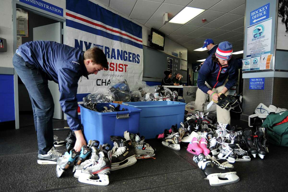 Members of the Rangers Hockey Development Team count pairs of skates donated by the Connecticut Barons during an equipment drive contest for Bantam-aged youth hockey players launched by the New York Rangers and Chase Bank at Stamford Twin Rinks in Stamford, Conn. on Saturday, March 26, 2016. The team that collects the most equipment will win an all-expenses paid five day hockey trip to Sweden.