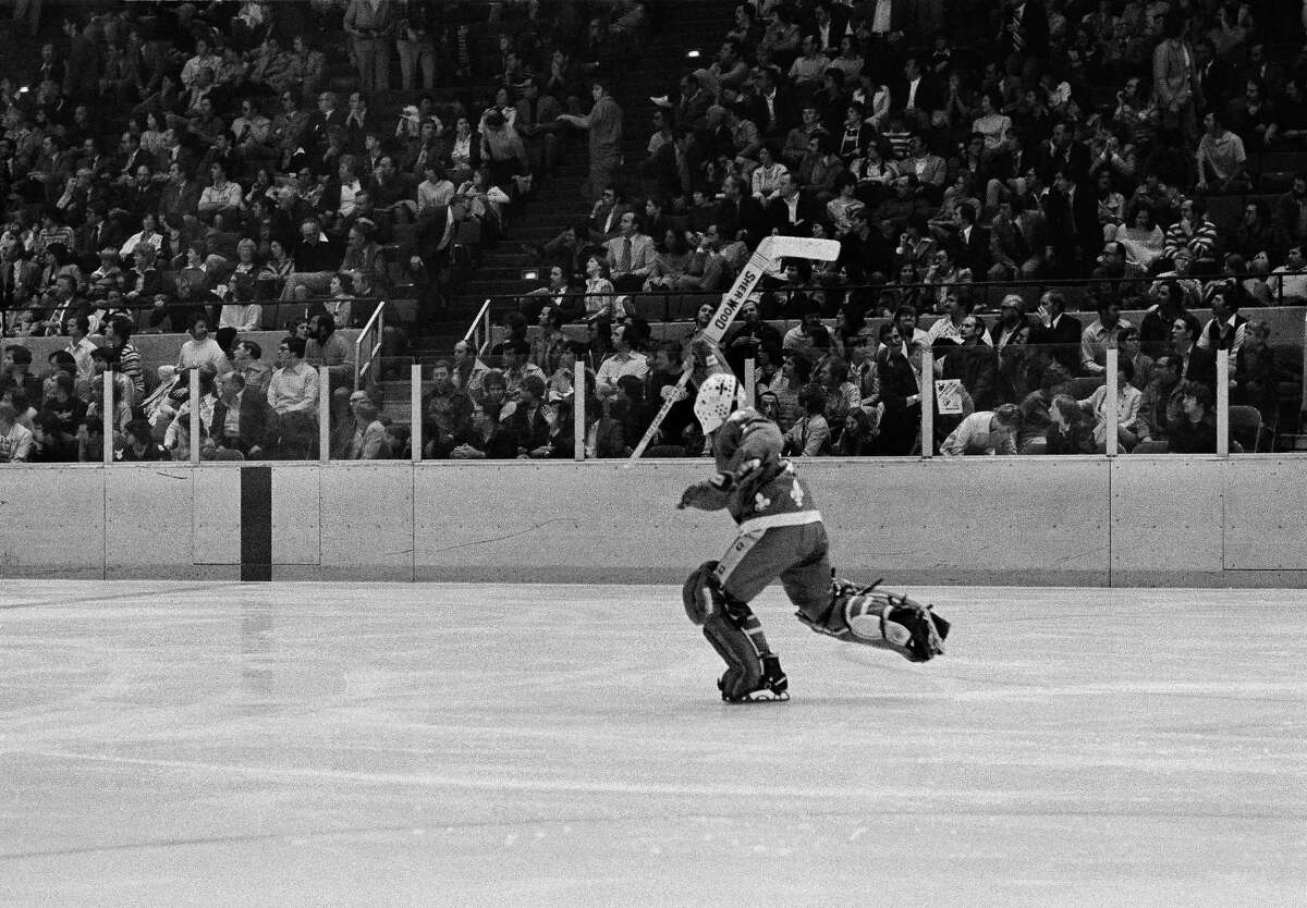 Goalie Richard Brodeur of the Quebec Nordiques, skates down the ice with his stick raised triumphantly after teammate Paul Baxter scored the winning goal against the New England Whalers with 1:50 gone in overtime during the first World Hockey Association playoff game in Hartford, Conn., April 15, 1977. The win gave Quebec a 3-0 lead in the best-of-seven series.