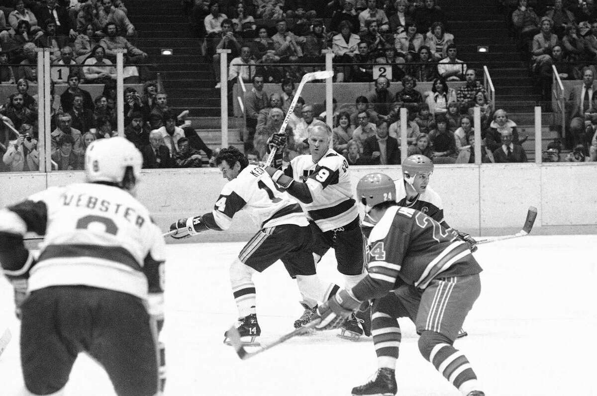 Gordie Howe (9 in white) pushes his way toward the puck in the second period of the New England Whalers-Winnipeg Jets World Hockey Association game in Hartford on Friday, Nov. 19, 1977. Howe, who joined the Whalers this season, was frustrated for the third consecutive game in his bid for his 1,000th career goal in the Friday game.