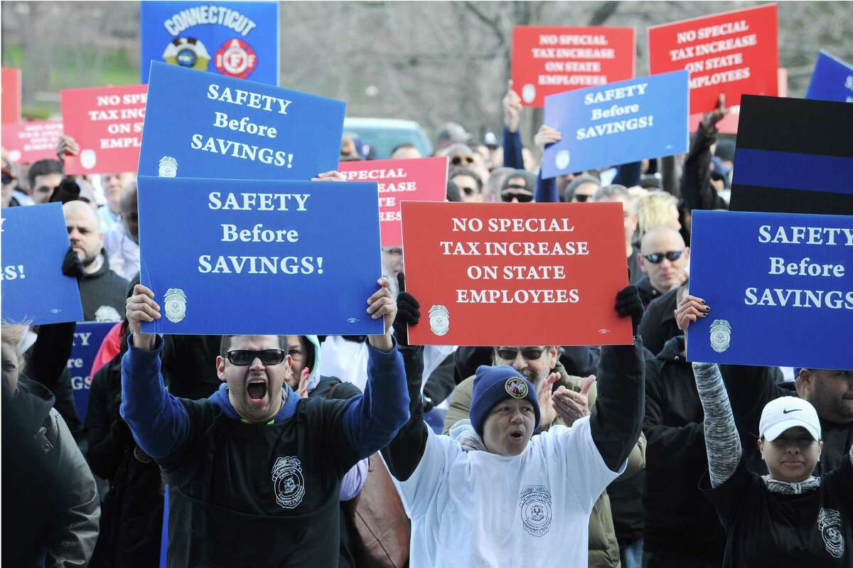 Hundreds of unionized state employees joined together outside of the Capitol to underscore how potential layoffs will affect Connecticut's quality of life on Tuesday, March 29, 2016 in Hartford, Conn.