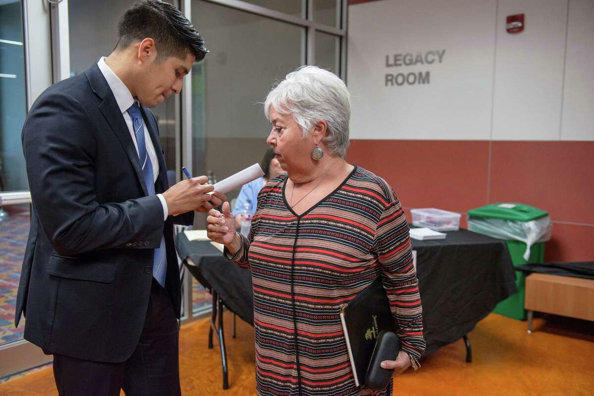 City Councilman Rey Saldana speaks with former South San High School teacher Mary Margaret Diaz during a community meeting for parents, community leaders and other members of the South San Antonio Independent School District at Palto Alto College in San Antonio, Texas on Tuesday, March 29, 2016.