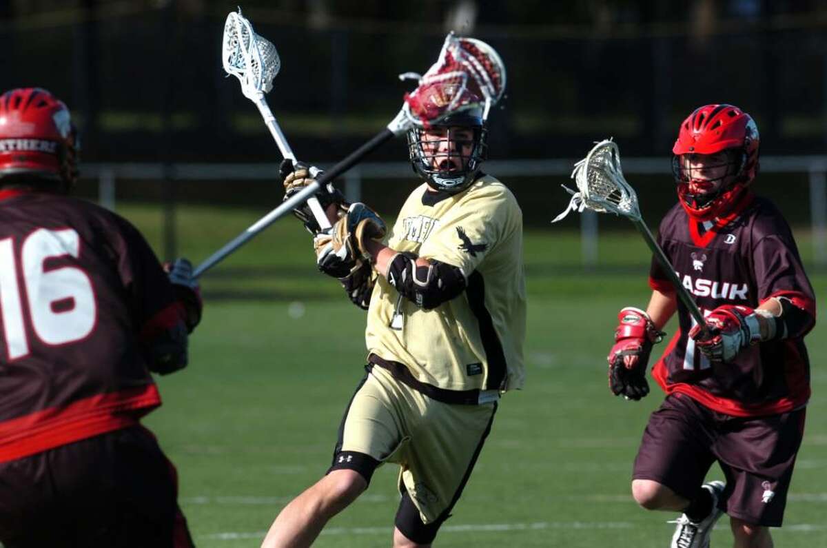 Trumbull's No. 7 Nick Nistico takes aim to score a goal between Masuk's No. 16 David Castillo and No. 11 Ryan Connor in the second quarter of Monday's game, at Trumbull High School.