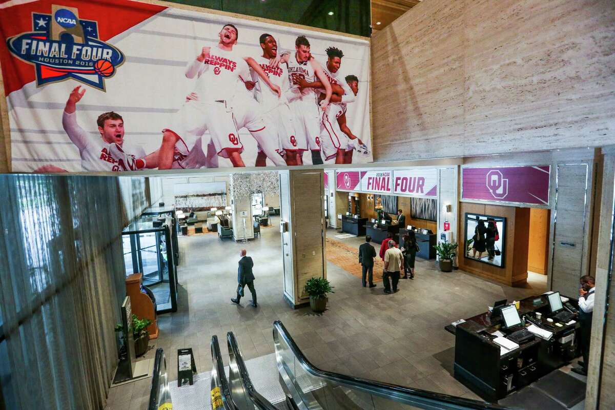 People walk through the hotel lobby of the Westin Galleria, the official NCAA hotel for the Oklahoma Sooners basketball team, as they prepare for the Final Four team to arrive Wednesday, March 30, 2016 in Houston.