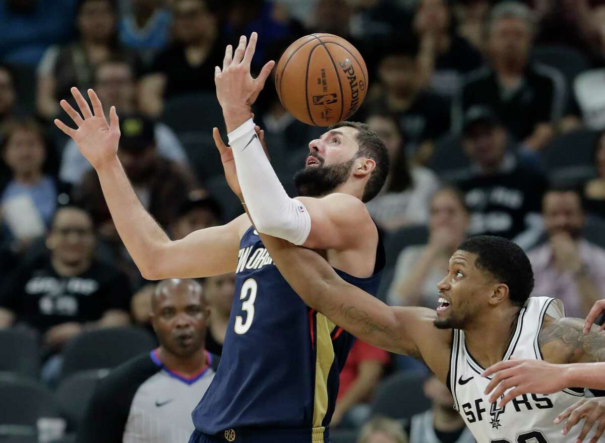 New Orleans Pelicans forward Nikola Mirotic (3) is fouled by San Antonio Spurs forward Rudy Gay as they scramble for a rebound during the first half of an NBA basketball game Wednesday, Feb. 28, 2018, in San Antonio. (AP Photo/Eric Gay)