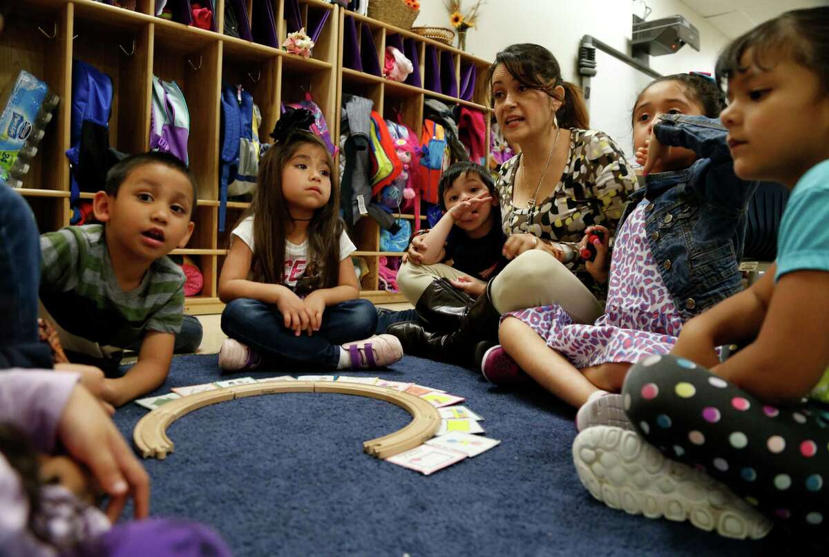 Teacher Maria Romero works with her Pre-K for SA South class at 7031 S. New Braunfels Ave. in March. Local school, government and business leaders are working together to create an advising system that starts when a student first enters school and continues through high school and into college to help ensure that they get the best opportunity for a successful life.