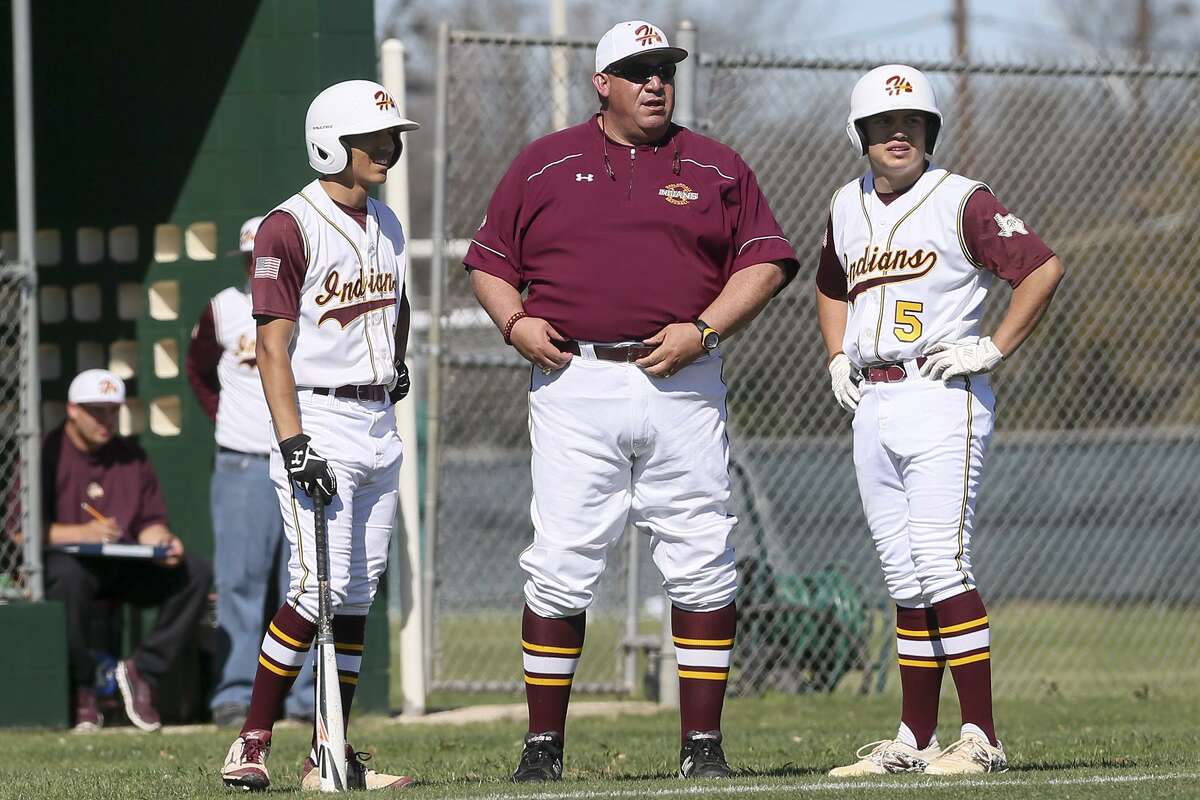 Harlandale baseball coach Eric Forestier (center) talks with John Navarro (right) and Robert Palomino during their game against Central Catholic at Tejada Sports Complex on Feb. 25, 2016.