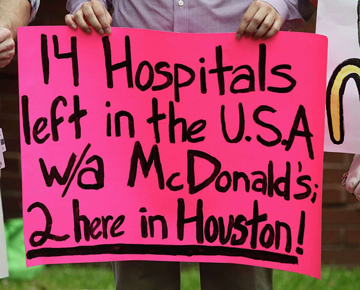 Value the Meal volunteers holds a sign while demonstrating in front of Harris Health after presenting a petition to the board to remove McDonald's from Ben Taub hospital Thursday, March 31, 2016, in Houston. ( James Nielsen / Houston Chronicle )