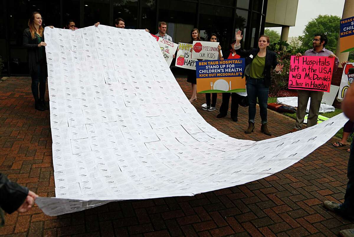 Value the Meal volunteers hold up 1100 signature petition to be given to the Harris Health board to remove McDonald's from Ben Taub Hospital Thursday, March 31, 2016, in Houston. ( James Nielsen / Houston Chronicle )