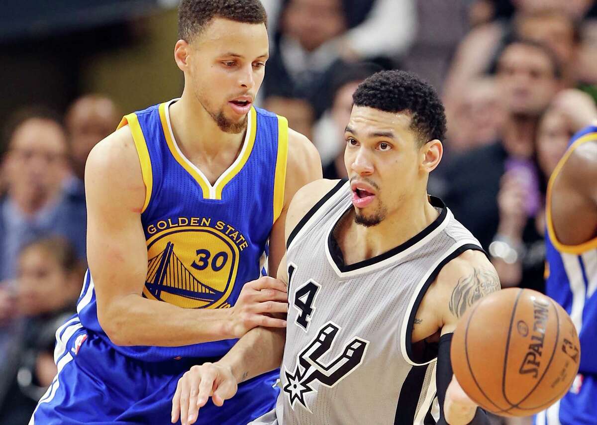 Spurs’ Danny Green looks to pass around Golden State Warriors’ Stephen Curry during second half action on March 19, 2016 at the AT&T Center.