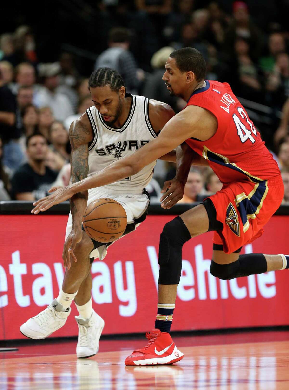 San Antonio Spurs' Kawhi Leonard steal the ball from New Orleans Pelicans' Alexis Ajinca during the first half at the AT&T Center, Wednesday, March 30, 2016.