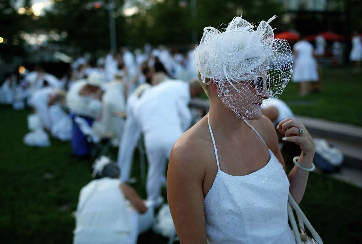A reveler at a Dinner en Blanc event in another city. The events happen around the country, and this will be the second year for San Antonio.