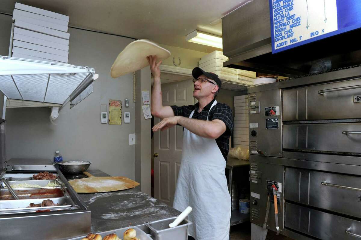 Blear Toci, owner of Bravo NY Danbury Road in New Milford, makes a pizza, Thursday, March 31, 2016.