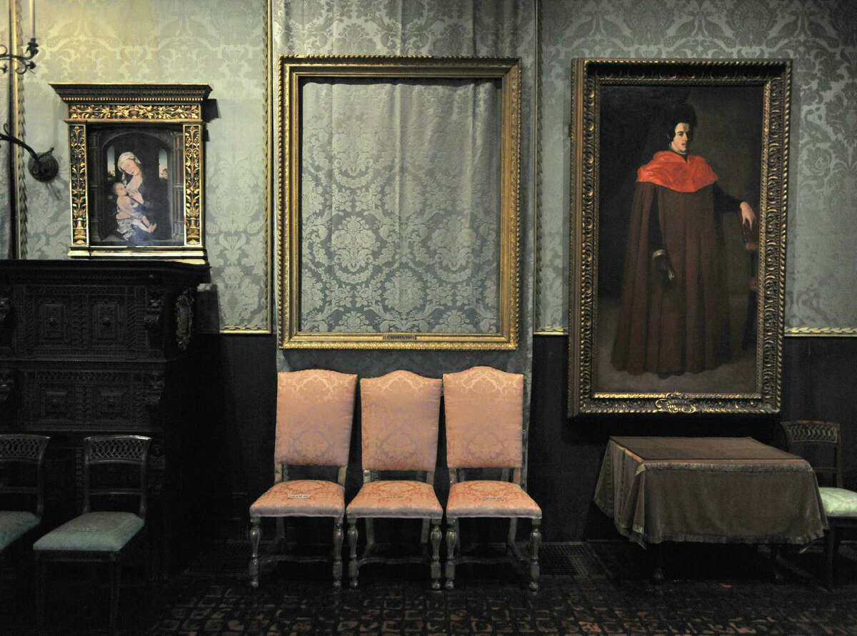 In this Thursday, March 11, 2010 photo, the empty frame, center, from which thieves cut Rembrandt's "Storm on the Sea of Galilee" remains on display at the Isabella Stewart Gardner Museum in Boston. The painting was one of more than a dozen works stolen from the museum in 1990 in what is considered the largest art theft in history. (AP Photo/Josh Reynolds)