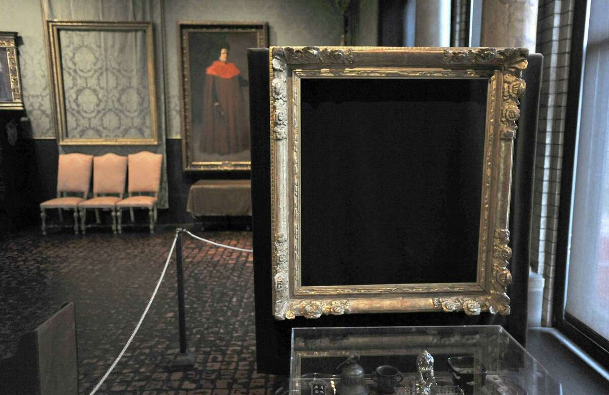 In this Thursday, March 11, 2010 photo, empty frames from which thieves took "Storm on the Sea of Galilee," left background, by Rembrandt and "The Concert," right foreground, by Vermeer, remain on display at the Isabella Stewart Gardner Museum in Boston. The paintings were among more than a dozen works stolen from the museum 20 years ago in what is considered the largest art theft in history. (AP Photo/Josh Reynolds)