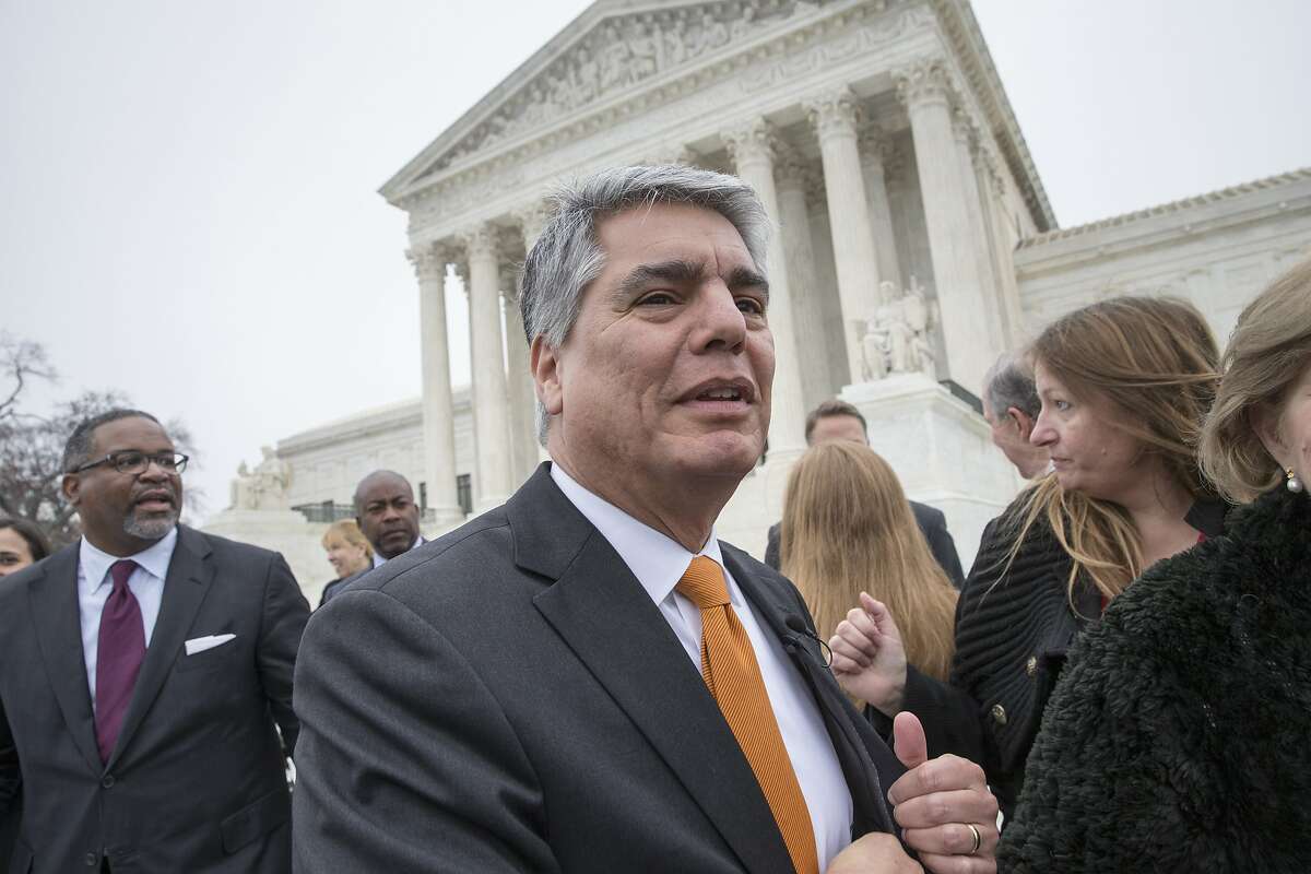 University of Texas at Austin President Gregory Fenves, center, and Gregory Vincent, left, UT's vice president for diversity, leave the Supreme Court in Washington, Wednesday, Dec. 9, 2015, following oral arguments in a case that could cut back on or even eliminate affirmative action in higher education. (AP Photo/J. Scott Applewhite)