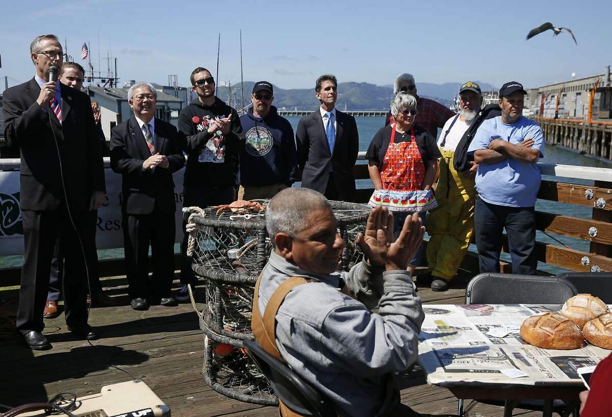 From left, Representative Jared Huffman speaks as he stands with Senator Mike McGuire, Mayor Ed Lee, Tim Sloane, Executive Director of Pacific Coast Federation of Fishermen's Associations, Mike Hudson, commercial salmon fisherman, Senator Mark Leno and Lori French along with other fishermen during a crab feed near Pier 45 on the Fisherman's Wharf April 1, 2016 in San Francisco, Calif.