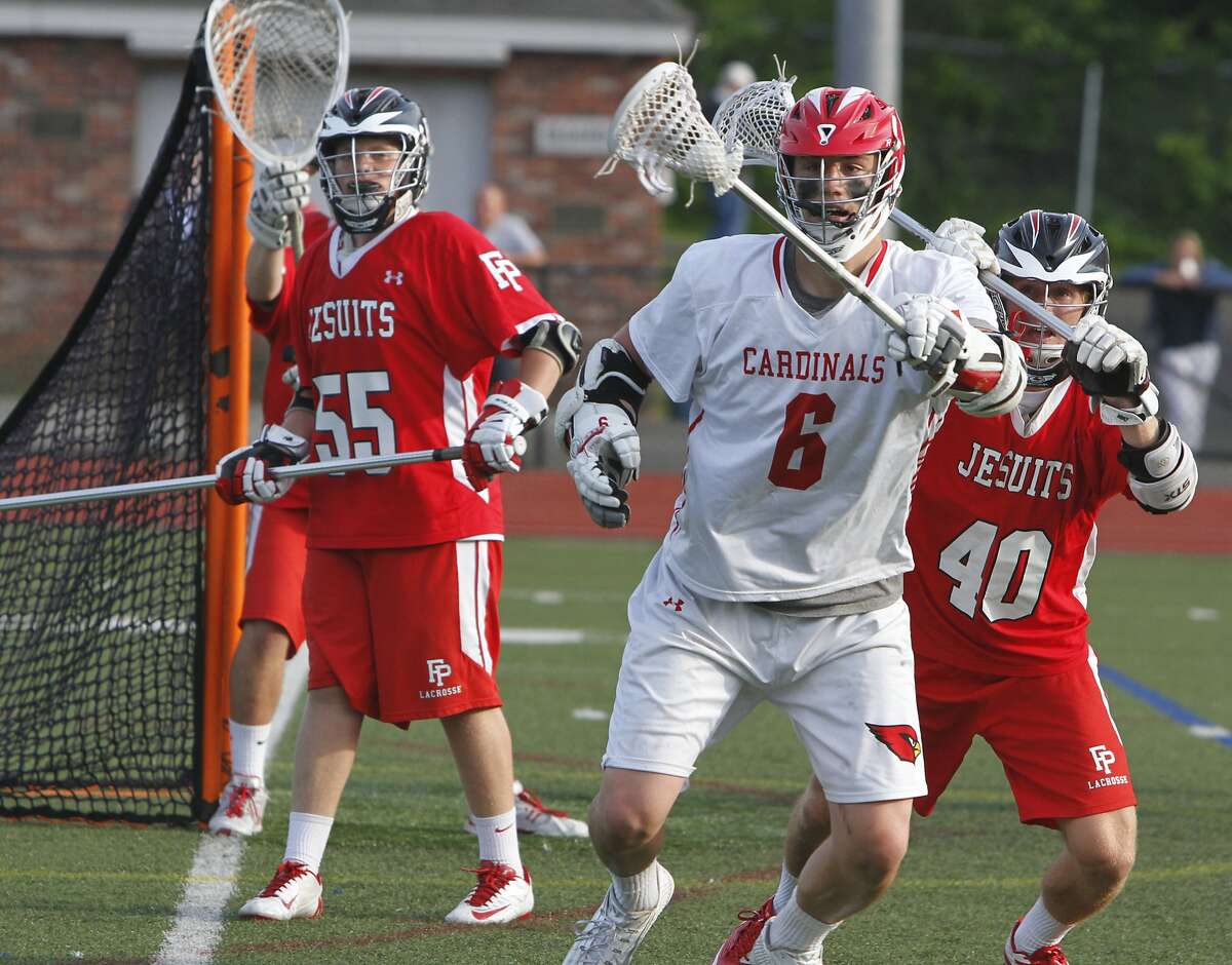 Greenwich's Scott Harrington controls a loose ball under pressure from Patrick Lambert, at right, during the first round Class L boys lacrosse at Greenwich High School in Greenwich, Conn. on Wednesday, June 3, 2015. Greenwich defeated Fairfield Prep 11-6.